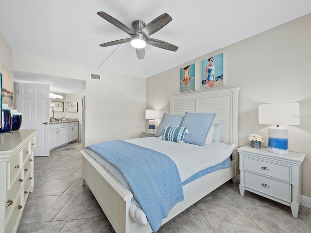 bedroom with ensuite bath and ceiling fan