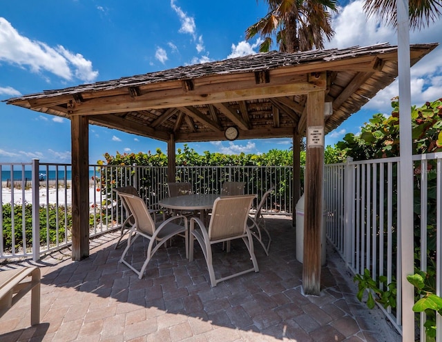 view of patio featuring a water view and a gazebo