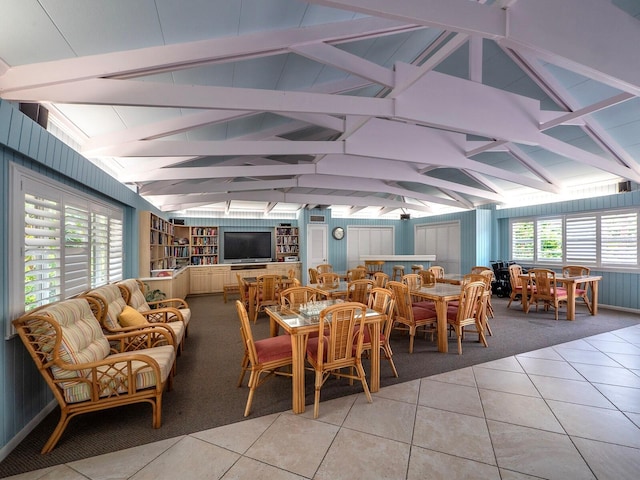 tiled dining area with vaulted ceiling and built in features