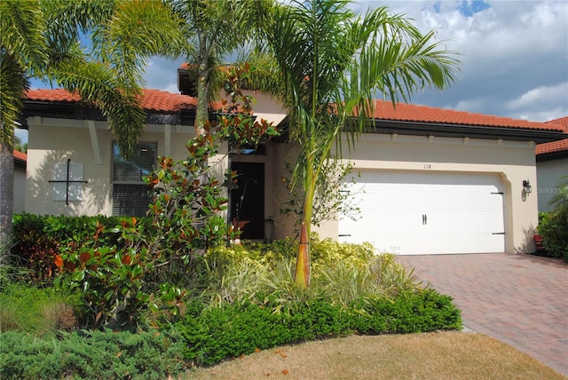 mediterranean / spanish home featuring a garage