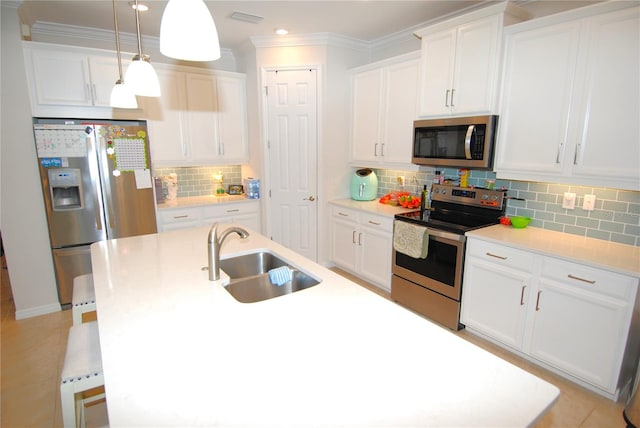 kitchen featuring decorative backsplash, pendant lighting, white cabinetry, sink, and stainless steel appliances