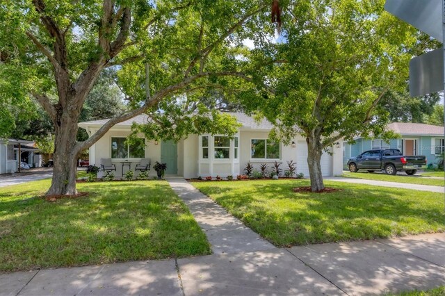 view of front of home with a front lawn and a garage