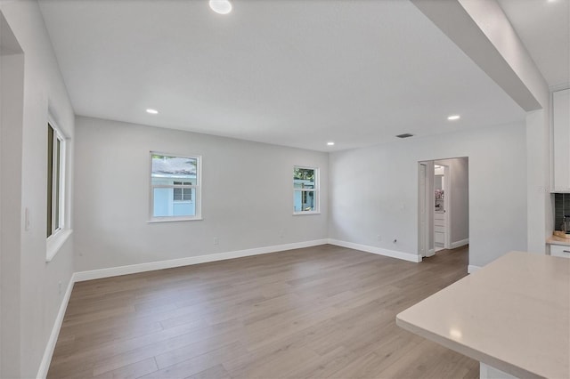 unfurnished living room with a fireplace and light hardwood / wood-style flooring