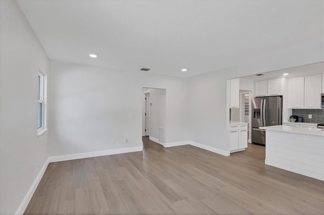 unfurnished living room featuring light wood-type flooring