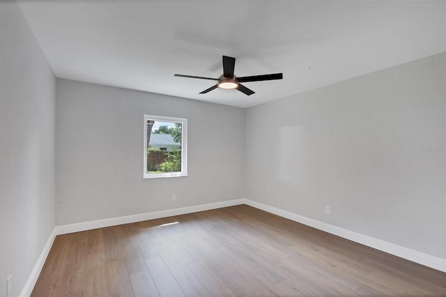 spare room with ceiling fan and wood-type flooring