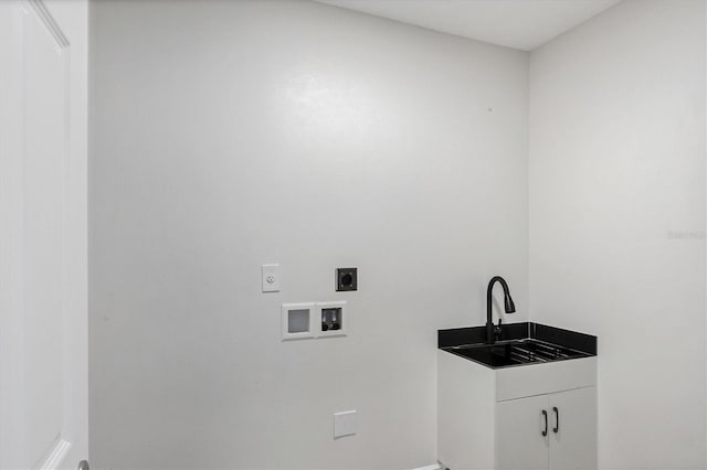 laundry area with sink, washer hookup, electric dryer hookup, and cabinets