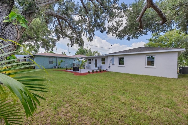 back of property featuring a patio area and a yard