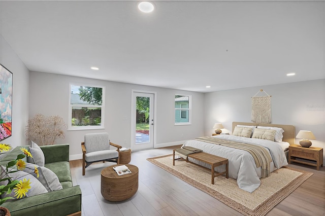 bedroom featuring light wood-type flooring and access to outside