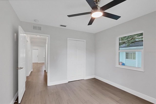 unfurnished bedroom featuring a closet, ceiling fan, and hardwood / wood-style flooring