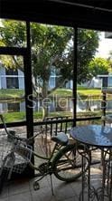 sunroom / solarium featuring a water view