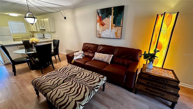 living area featuring wood finished floors and baseboards