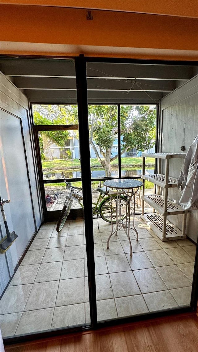 doorway featuring wood walls and hardwood / wood-style floors