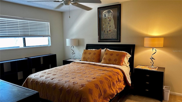 carpeted bedroom with baseboards and a ceiling fan