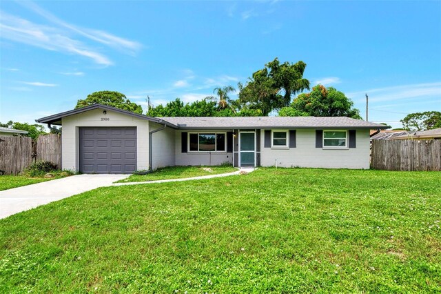 single story home featuring a front yard and a garage