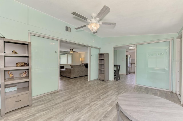 2900 Siesta Dr, Venice, FL 34293 - bedroom with wood finished floors, visible vents, a ceiling fan, a closet, and freestanding refrigerator