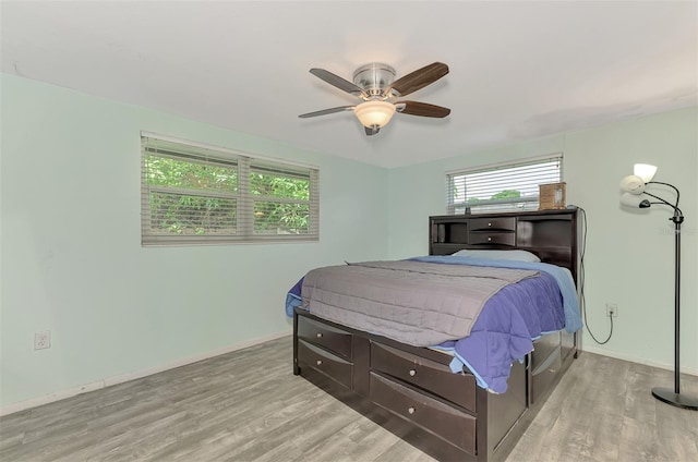 2900 Siesta Dr, Venice, FL 34293 - bedroom featuring wood finished floors, a ceiling fan, and baseboards