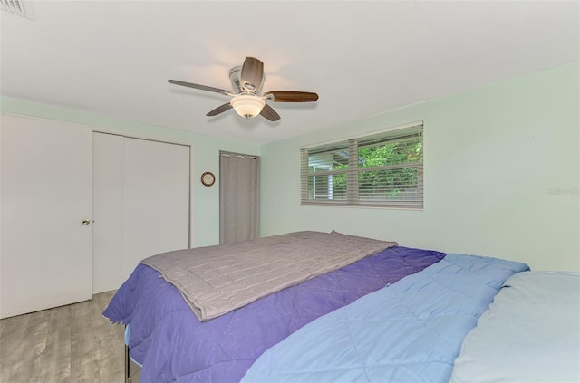 2900 Siesta Dr, Venice, FL 34293 - bedroom featuring multiple closets, light wood-type flooring, visible vents, and a ceiling fan