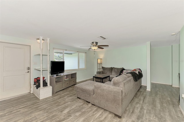 living room with ceiling fan and light wood-type flooring