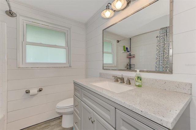2900 Siesta Dr, Venice, FL 34293 - bathroom with a wealth of natural light, toilet, vanity, wood finished floors, and a shower with curtain