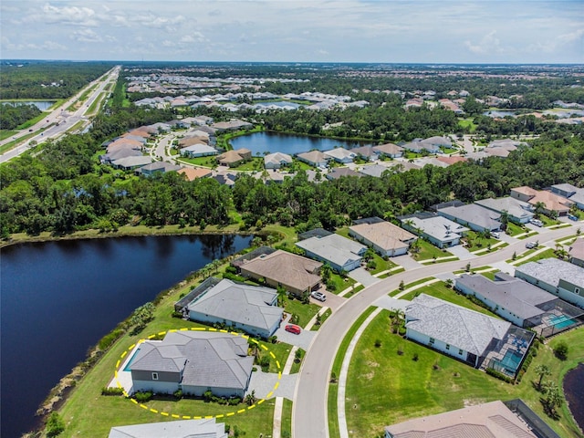 drone / aerial view featuring a water view and a residential view