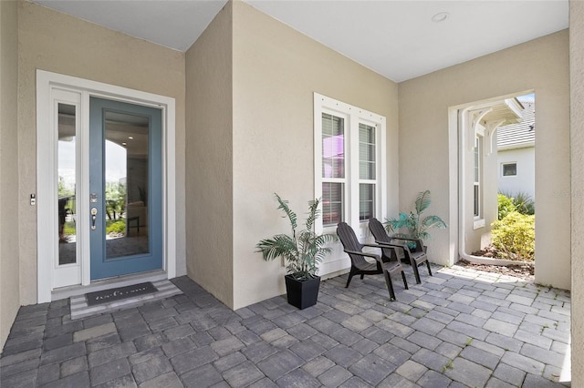 property entrance featuring stucco siding