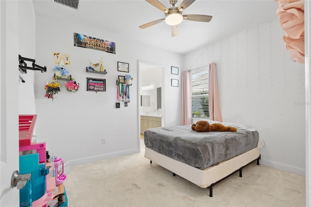 carpeted bedroom featuring a ceiling fan, visible vents, baseboards, and connected bathroom