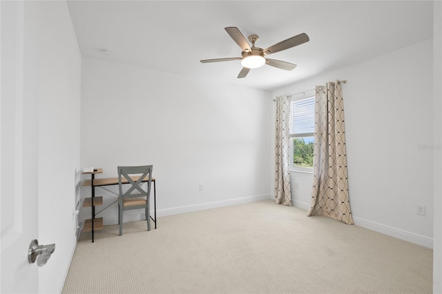 carpeted spare room with ceiling fan and baseboards