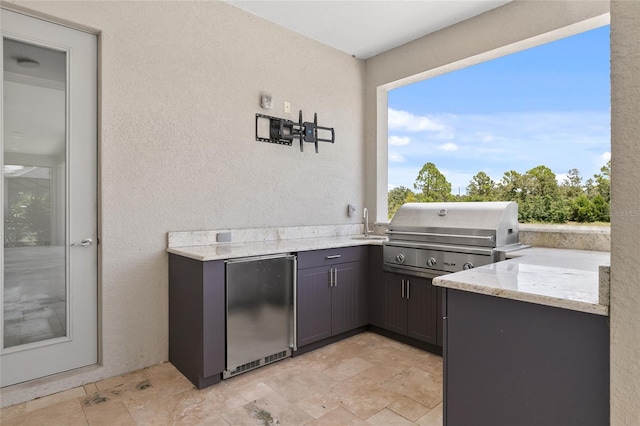 view of patio featuring a sink, area for grilling, and a grill