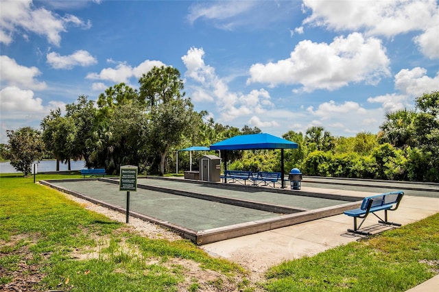 surrounding community featuring a lawn and a storage shed