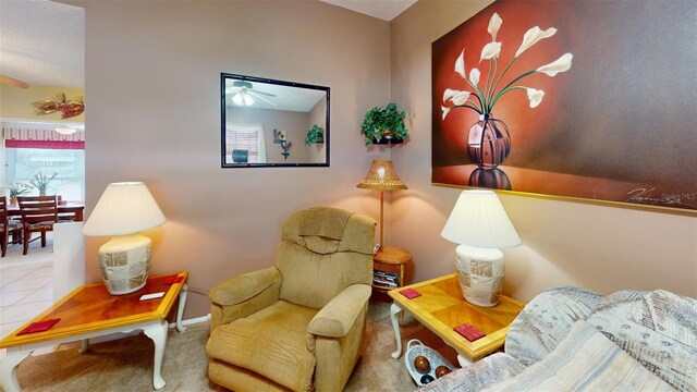 interior space featuring ceiling fan, a textured ceiling, and carpet flooring