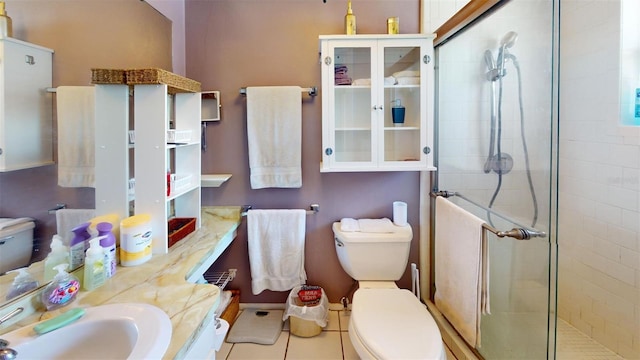 bathroom with toilet, tile patterned floors, a shower stall, and vanity