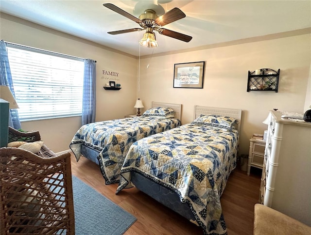 bedroom with ceiling fan and hardwood / wood-style floors