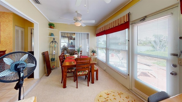 carpeted dining room featuring ceiling fan