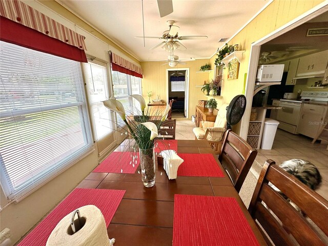 tiled dining space featuring ceiling fan