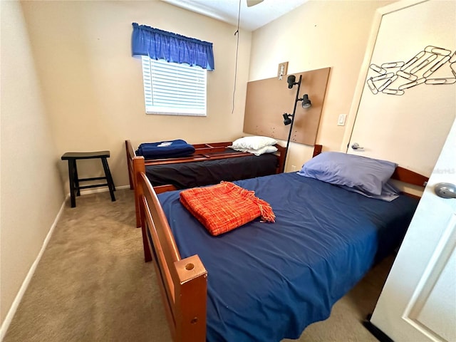 bedroom with baseboards and carpet flooring