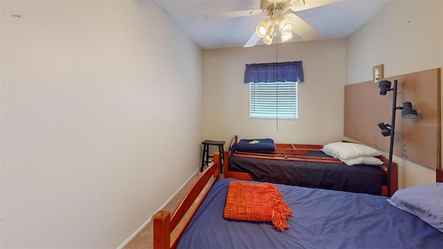 bedroom with a textured ceiling, carpet, a ceiling fan, and baseboards