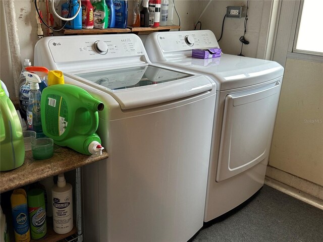 clothes washing area featuring separate washer and dryer