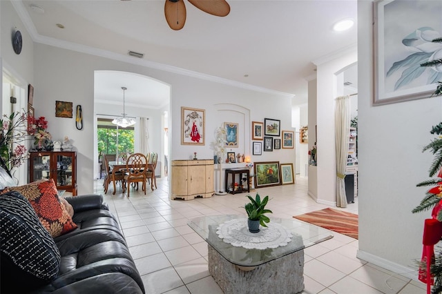 living room featuring ceiling fan with notable chandelier, light tile patterned floors, and ornamental molding