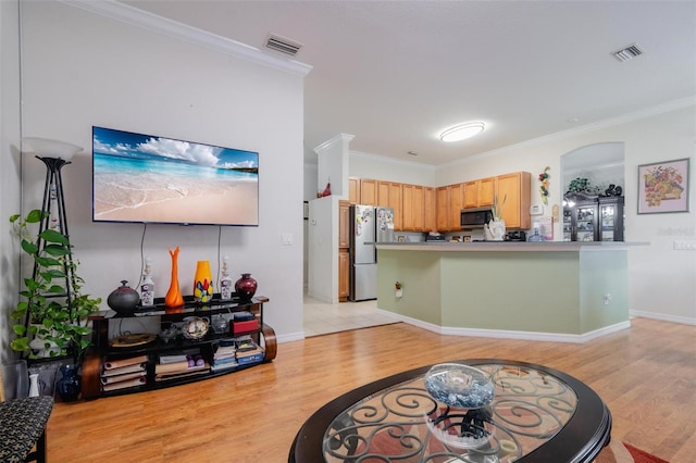 kitchen with stainless steel appliances, light brown cabinetry, light tile patterned floors, and crown molding