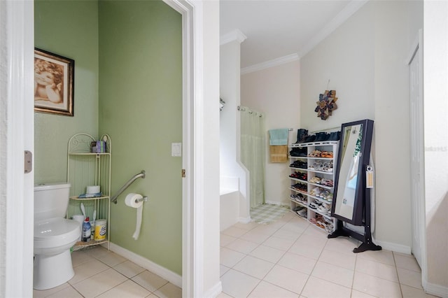 bathroom with bathtub / shower combination, crown molding, toilet, and tile patterned flooring