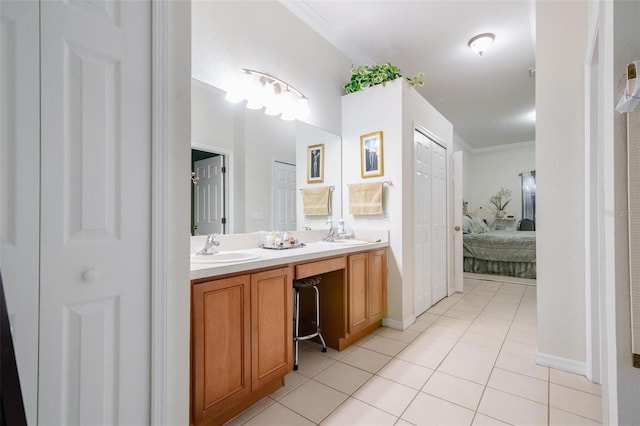 bathroom featuring ornamental molding, double sink vanity, and tile patterned floors