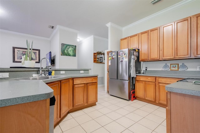 kitchen featuring sink, light tile patterned floors, stainless steel fridge, and ornamental molding