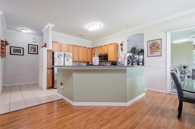 kitchen with light wood-type flooring, stainless steel appliances, ornamental molding, and kitchen peninsula