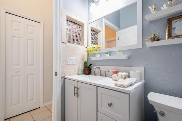 bathroom with tile patterned floors, vanity, and toilet