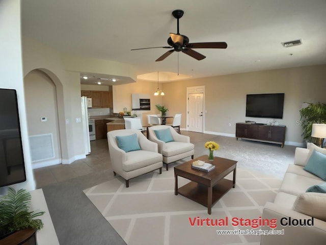 living room featuring ceiling fan and light tile patterned floors