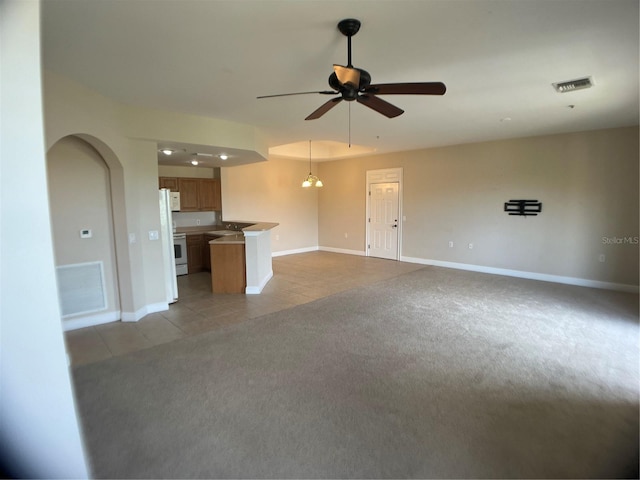 unfurnished living room with ceiling fan and light tile patterned floors