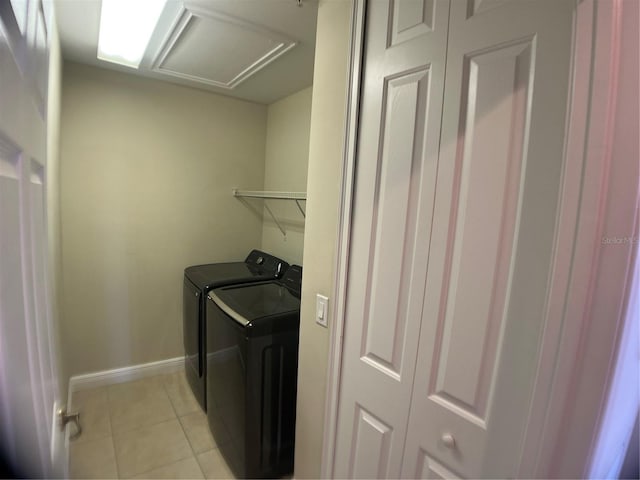 washroom featuring light tile patterned floors and washer and clothes dryer