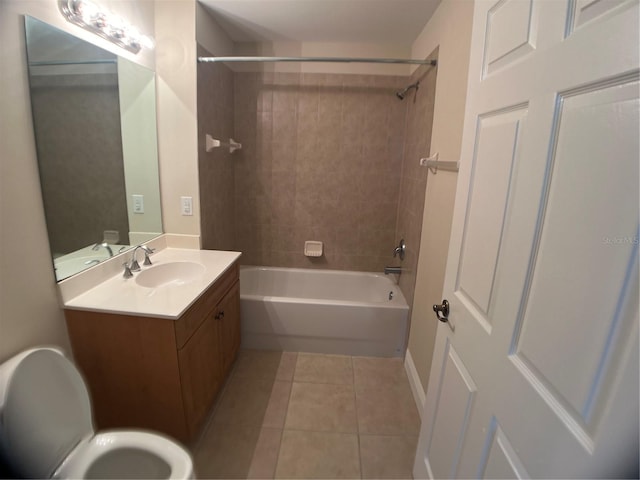 full bathroom with tile patterned flooring, vanity, tiled shower / bath combo, and toilet