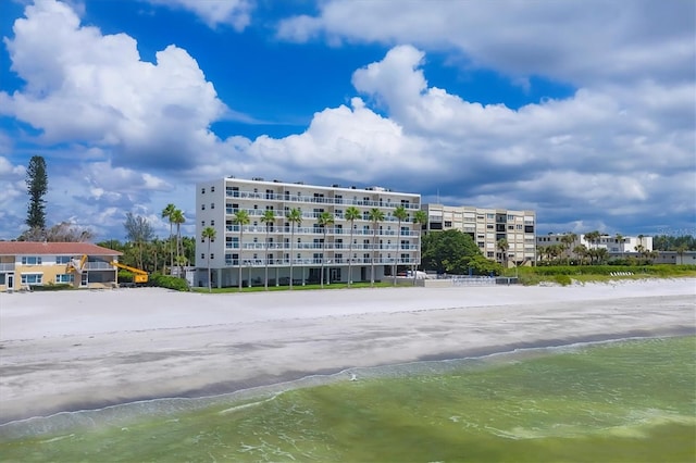 view of building exterior with a view of the beach and a water view