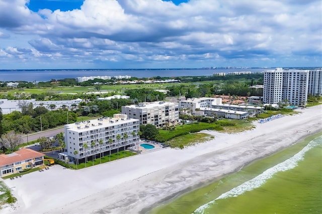 birds eye view of property with a beach view and a water view